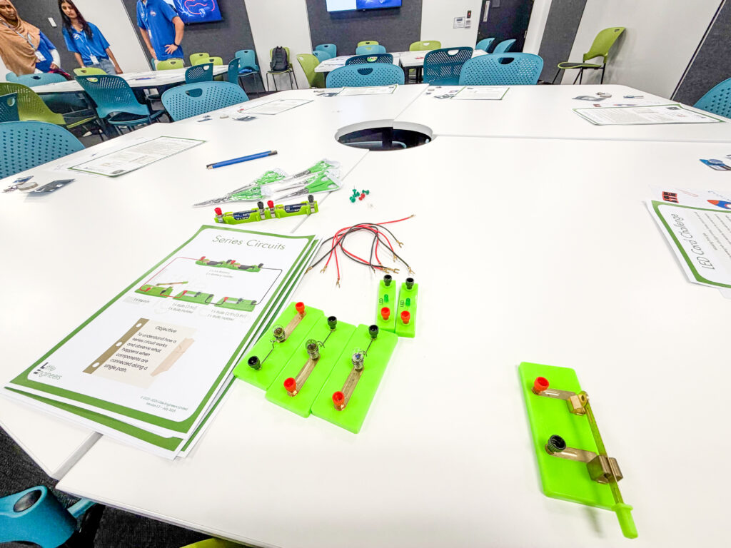 Little Engineers STEM activity setup with circuit components on a white table.