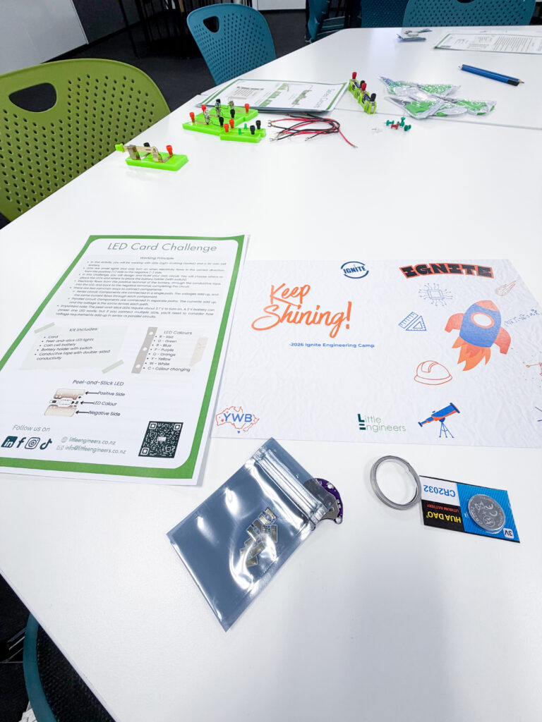 Little Engineers LED Card Challenge setup with electronic components on a white table.