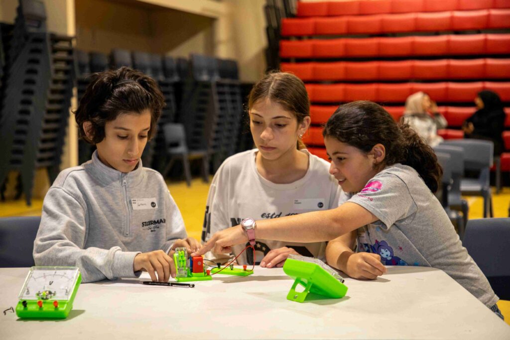 Young girls engaging in electronics workshop at Little Engineers event.