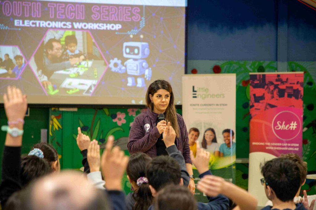 Young girl leading a tech workshop at Little Engineers event.