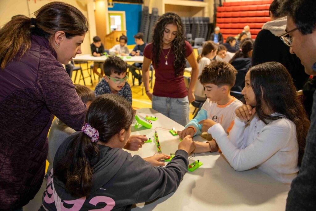 Children and instructors engaging in a hands-on electronics workshop at Little Engineers.
